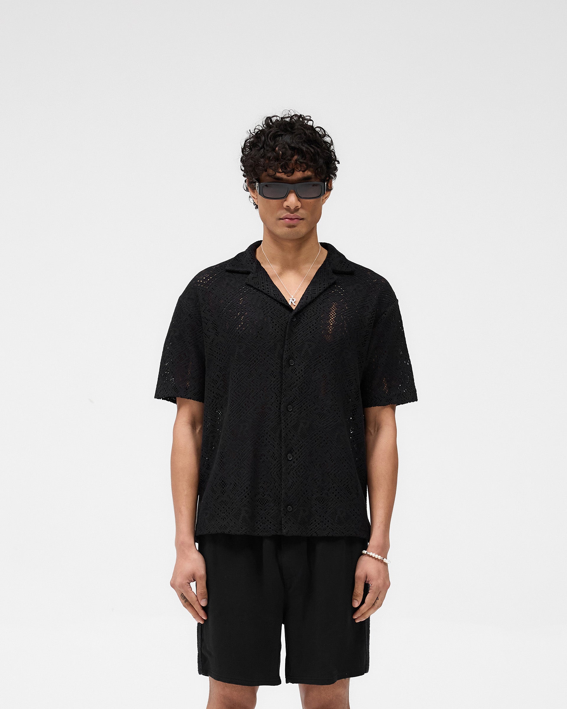 Man wearing an oversized black crochet shirt on a plain white background | All Over Crochet Shirt in Jet Black | Crochet shirt with