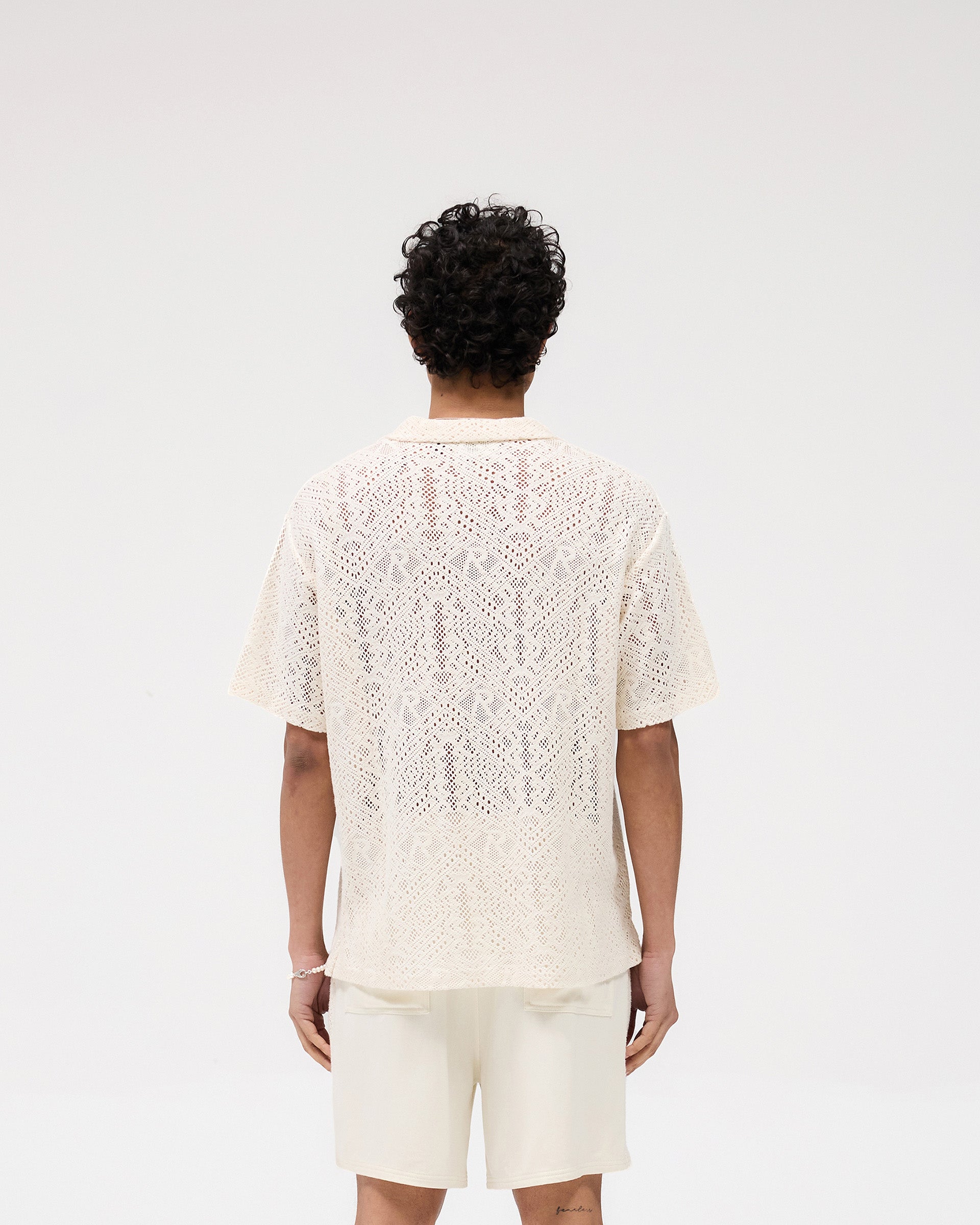 Model wearing an off white crochet shirt on a plain white background | All Over Crochet Shirt in Off White | Open-knit crochet with