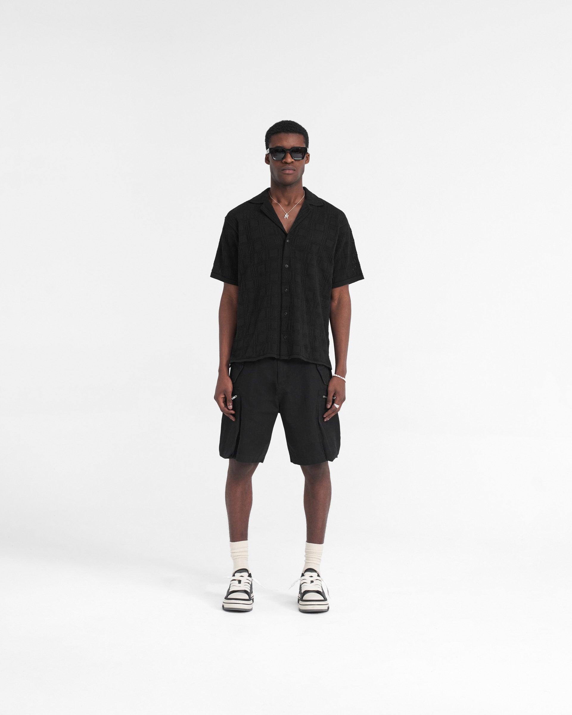 Man wearing a black lace knit shirt on a plain white background | Lace Knit Shirt in Black | Oversized shirt with crochet pattern | SS24 Shirts | Represent Clo