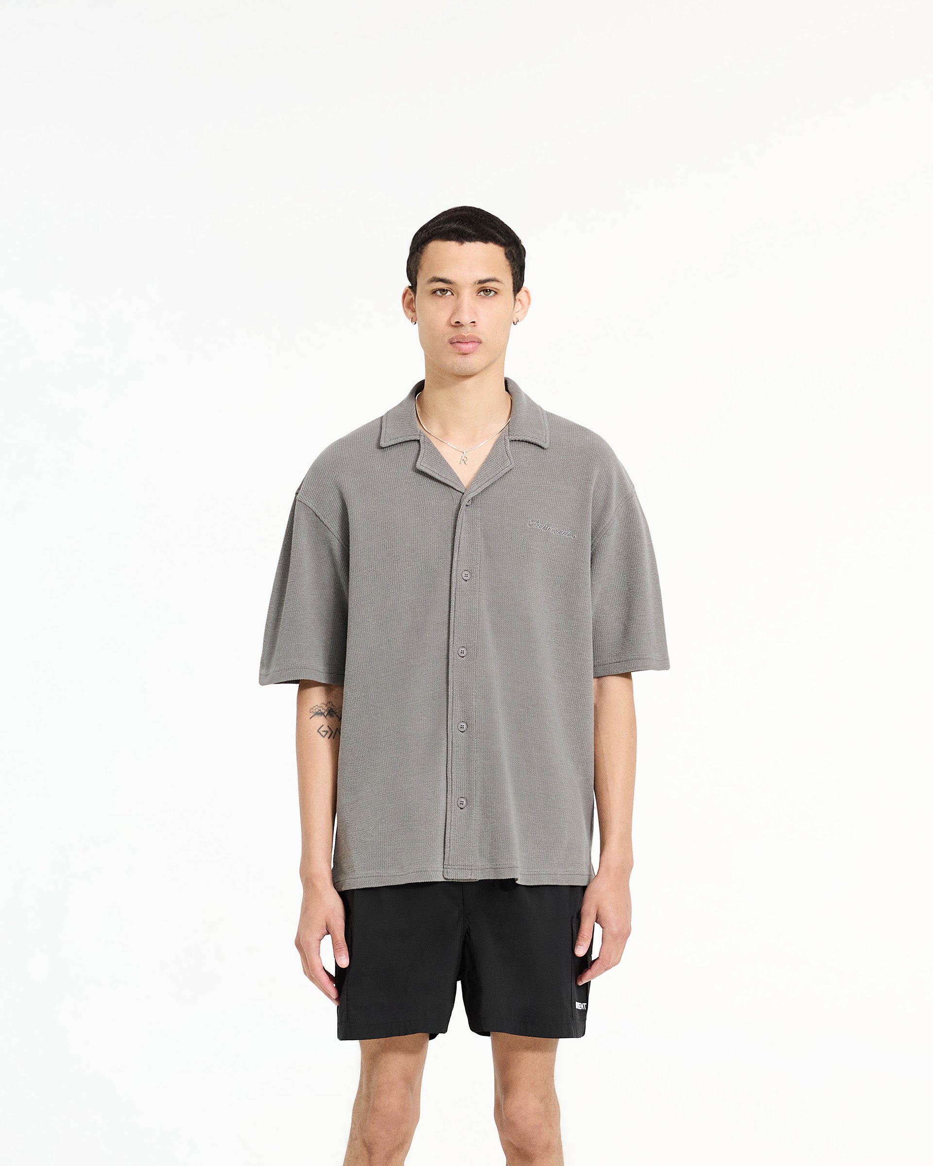 Man wearing a grey waffle shirt on a plain white background | Waffle Shirt in Ultimate Grey | Drapey shirt with revere collar and side split hem | SC24 Shirts | Represent Clo