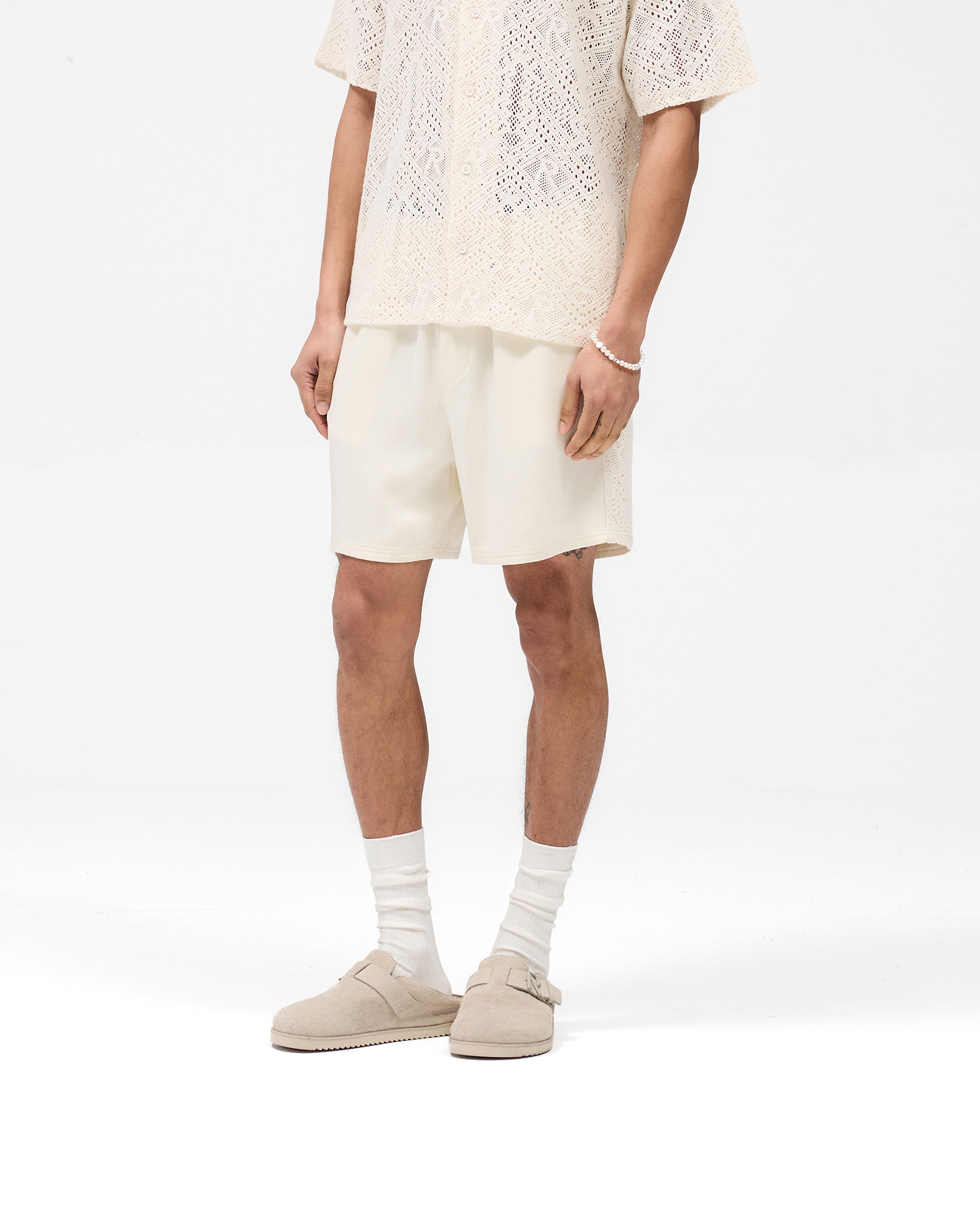 Back product image of mens white shorts on a plain white background | Knitted Panel Short in Antique White | Shorts with knitted panel and elasticated waistband | SS25 Shorts | Represent Clo