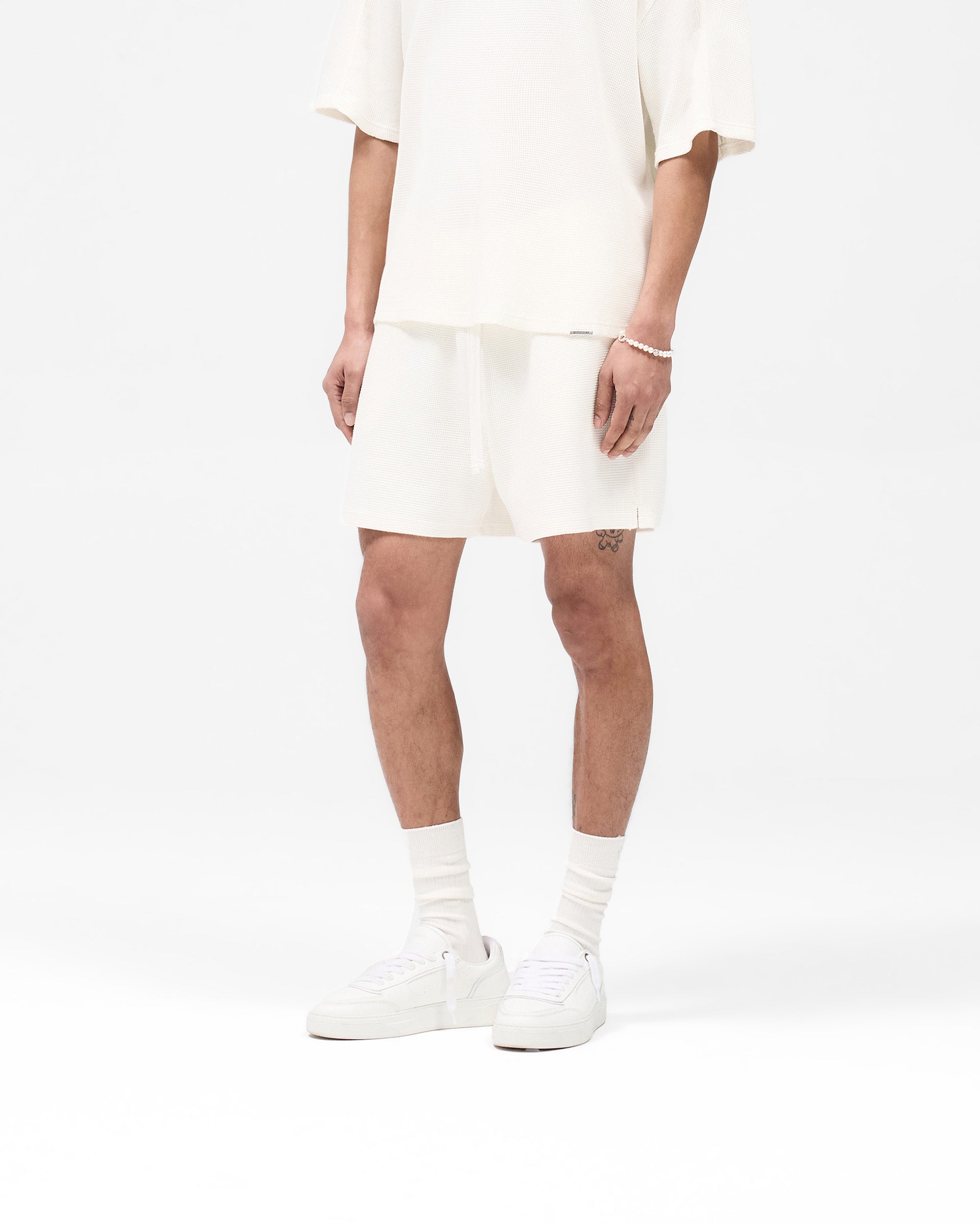Back product image of mens white shorts on a plain white background | Waffle Shorts in White | Heavyweight waffle fabric shorts with elasticated waistband | SS25 Shorts | Represent Clo