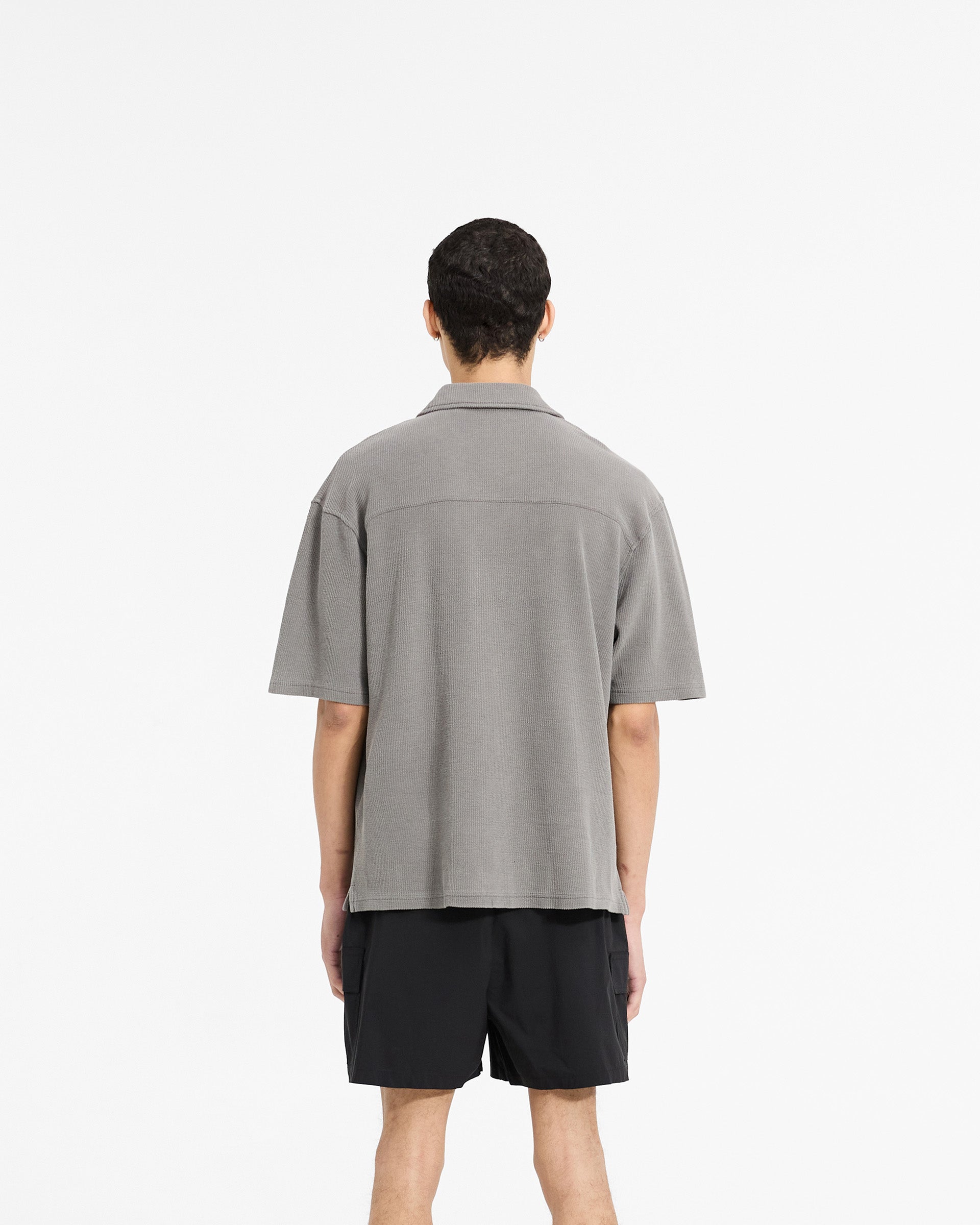 Man wearing a grey drapey shirt on a plain white background | Waffle Shirt in Ultimate Grey | Drapey fit shirt with revere collar | SC24 Shirts | Represent Clo